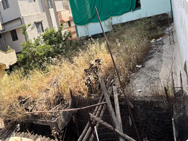 Neglected Old Terrace with Overgrown Weeds and Damp Walls