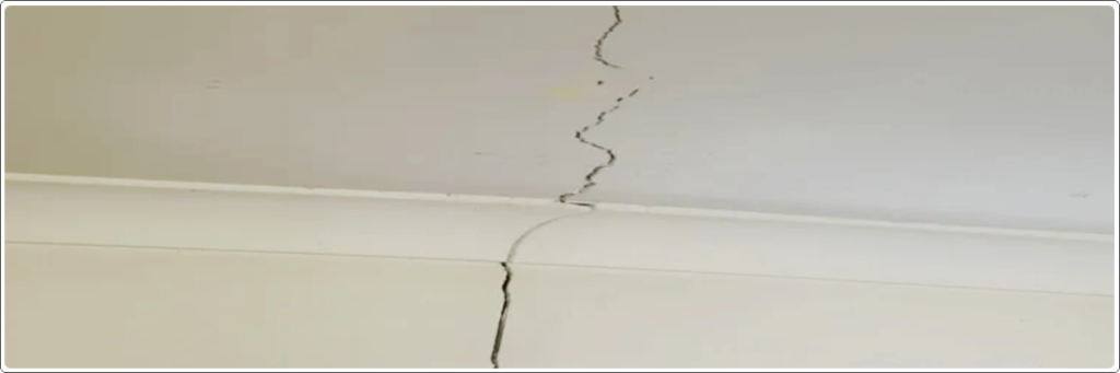 Visible ceiling crack caused by terrace water damage